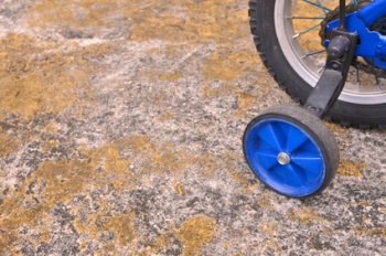 Training wheels on a blue children's bicycle